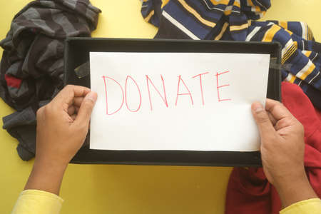 holding a paper with hand written donation text top viewの写真素材