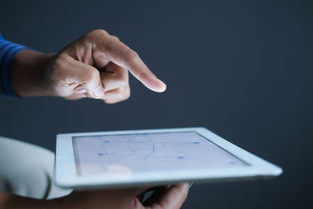 analyzing stock market data on digital tabletの写真素材