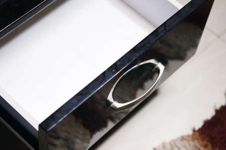 mans hand open drawer wooden in cabinetの写真素材