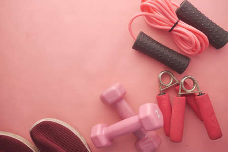 pink color dumbbell, exercise mat and water bottle on white backgroundの写真素材