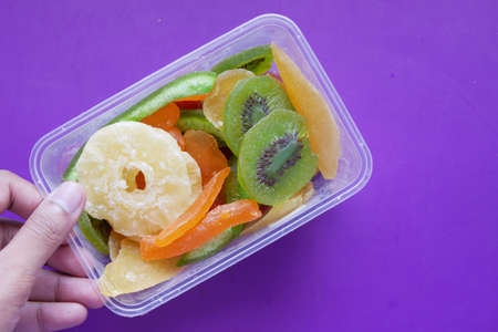 Dried fruits and berries on purple backgroundの写真素材