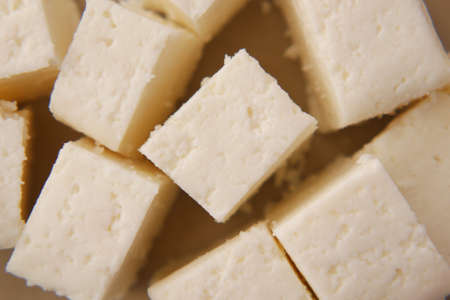close up of cube shape fresh cheese on white background.の写真素材