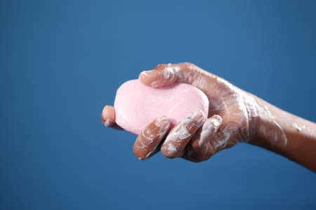 young man washing hands with soap warm waterの写真素材