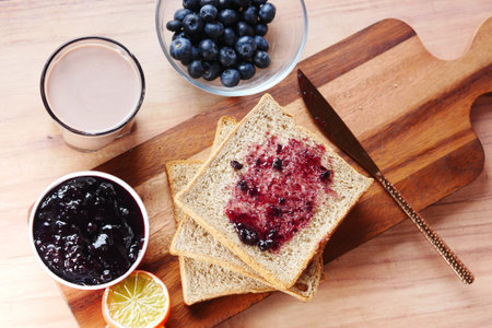 blue berry jam on bread on table,