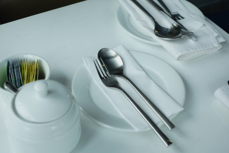 cutlery and empty plate on wooden background top downの写真素材