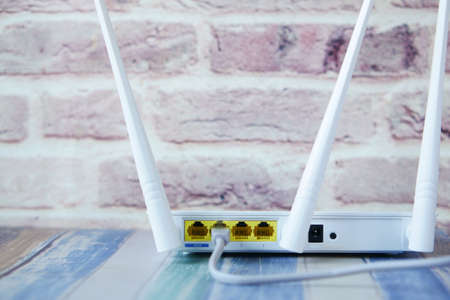 Wi-Fi router with cables on tableの写真素材