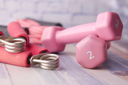 pink color dumbbell, exercise mat and water bottle on white backgroundの写真素材