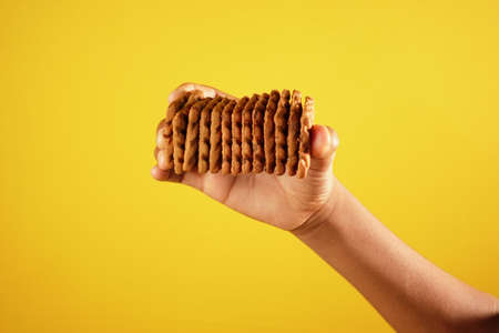 hand hold stack of chocolate cream cookingの写真素材