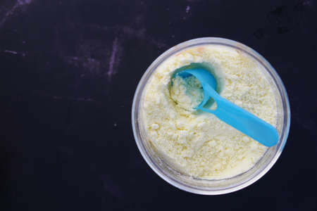 Close up of baby milk powder and spoon on tile background.の写真素材