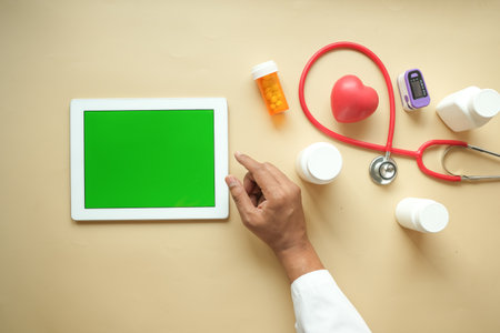 doctor in white coat is using a digital tablet, top downの写真素材