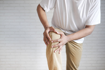 man suffering knee joint pain with copy spaceの写真素材