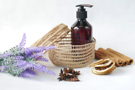 eucalyptus essential oils in a glass bottle and flower on tableの写真素材