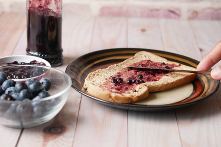blue berry jam on bread on table,の写真素材