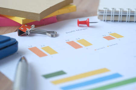 financial graph, calculator and notepad on tableの写真素材