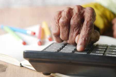 senior women hand using calculator on deskの写真素材