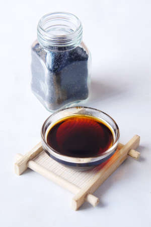 Black Cumin oil in a container on table.の写真素材