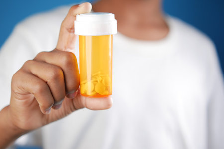 young man hand holding medicine pill containerの写真素材