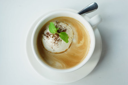 a cup of late coffee with ice cream on table