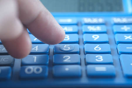 Close up of man hand using calculatorの写真素材