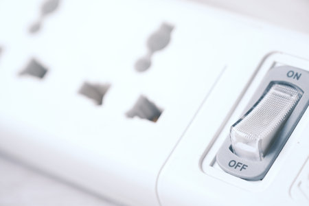 Electrical switch and plug on color background,