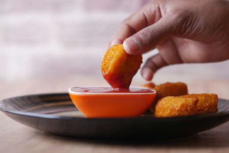 close up of chicken nugget and sauce on tableの写真素材