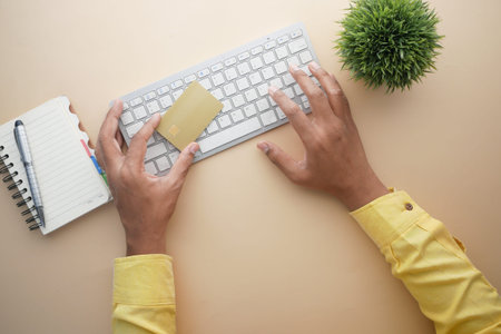 man hands holding credit card and using laptop shopping online