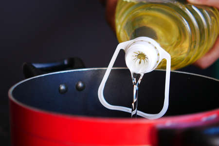 sunflower oil pouting in a cooking panの写真素材