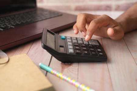 Close up of man hand using calculatorの写真素材