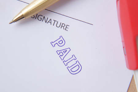 Paid invoice and Rubber Stamp on paper ,の写真素材