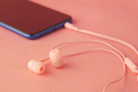 smart phone and headphone on wooden background .