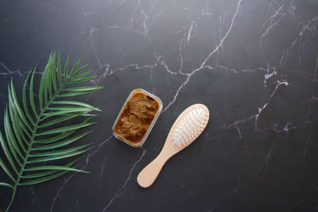 The wooden bowl with rehydrated henna on tableの写真素材