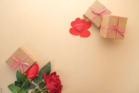 Top view of gift box, envelope and rose flower on yellow backgroundの写真素材