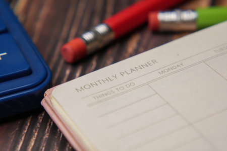 close up of weekly planner and notepad on tableの写真素材