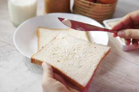 butter spreading on a bread close up