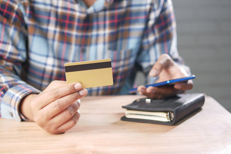 hand holding credit card and smart phone shopping onlineの写真素材