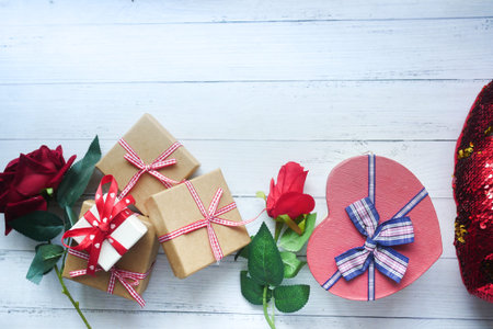 Top view of gift box and rose flower on color backgroundの写真素材