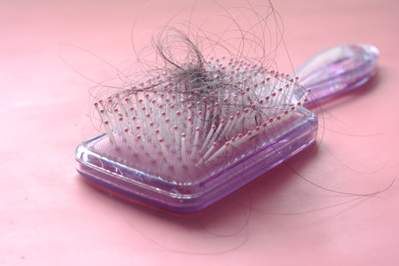a brush with lost hair on tableの写真素材
