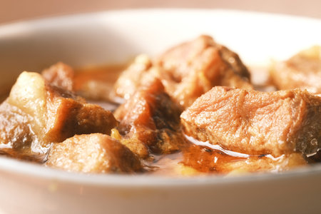 traditional Indian curry lamb masala in a bowl on table