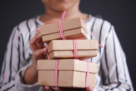 child hand hold homemade gift boxの写真素材