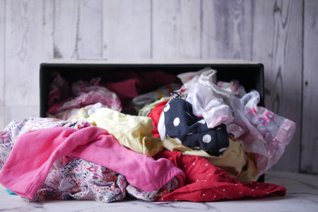 Donation box with donation clothes on a wooden table .の写真素材