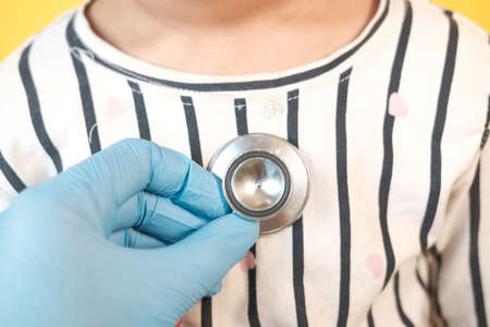 Doctor using a stethoscope checking child body, close upの写真素材