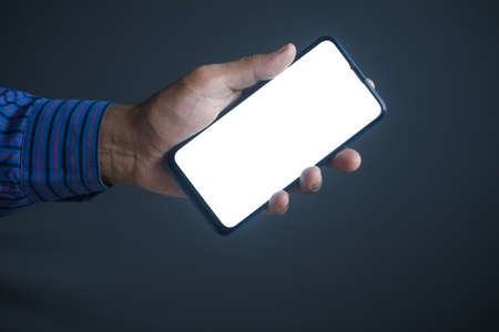 Close up of young man hand using smart phone with green screenの写真素材