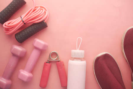 pink color dumbbell, exercise mat and water bottle on white backgroundの写真素材