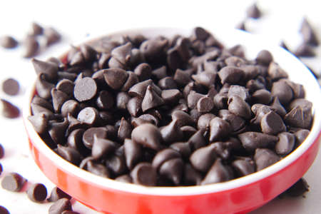 Chocolate chips spilling from a plastic packet,の写真素材