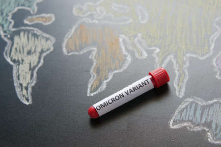 omicron variant corona virus blood test tube and world mapの写真素材