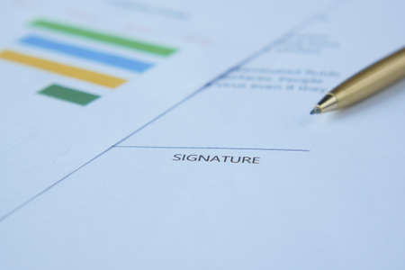 close up of signature on a contact on tableの写真素材