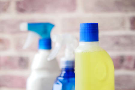 floor cleaning disinfect bottle against brick wallの写真素材