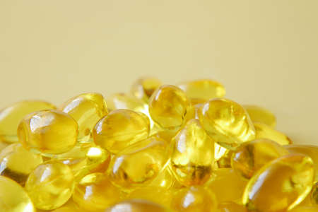 fish oil supplement on orange backgroundの写真素材