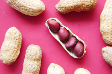 Processed pea nuts on red background close upの写真素材