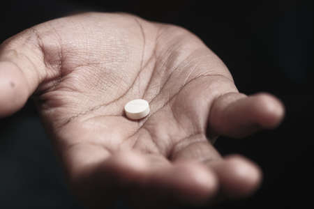 Close up of man hand holding pills with copy spaceの写真素材
